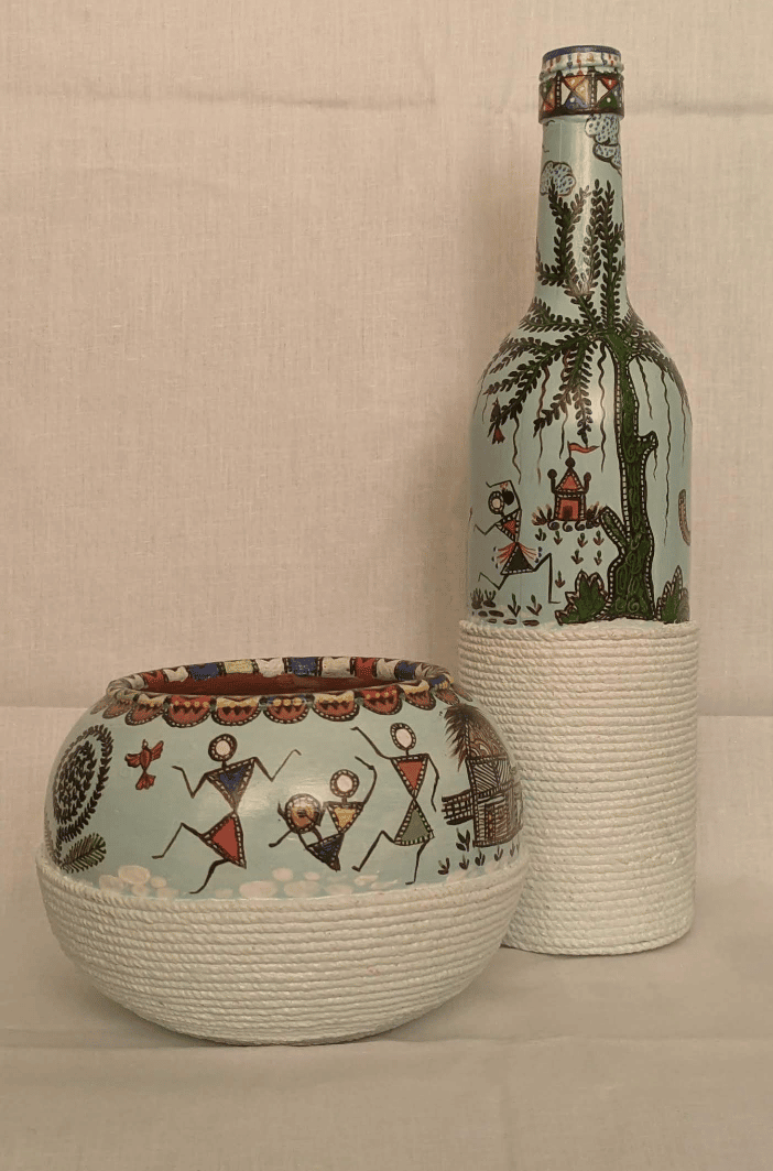 WARLI PAINTING ON A GLASS BOTTLE AND A TERRACOTTA POT